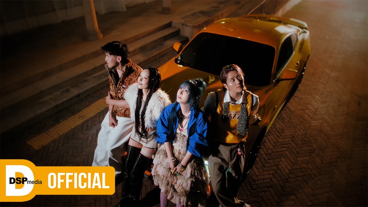 KARD üyeleri Back To Life klibinden bir karede sarı bir otomobilin önünde
